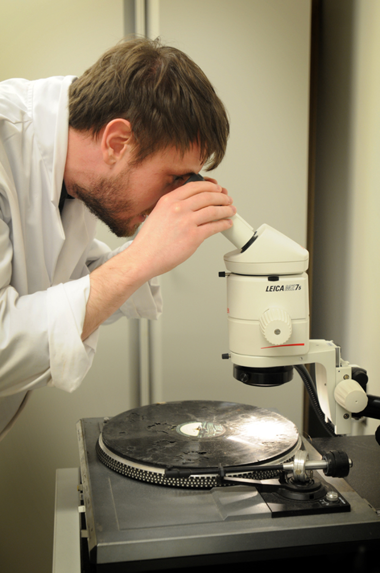 Damaged gelatine disc being examined in the British Library sound archive. Photo by Clare Kendall