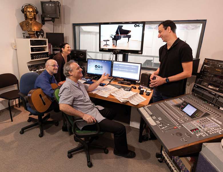 Tomer Lev (second from right) in the control room