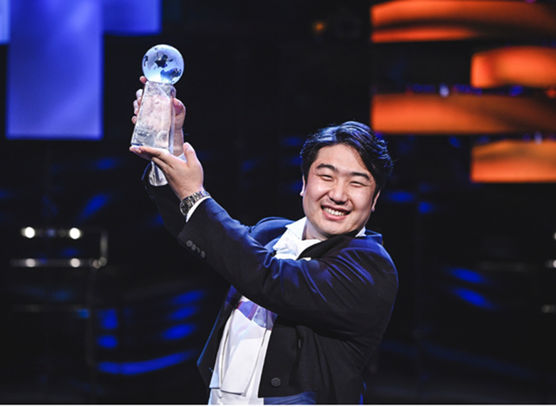 Baritone Gihoon Kim lifts the BBC Cardiff Singer of the World trophy